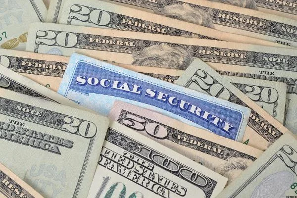 social security card in pile of money 600x400 1 56203e8912487
